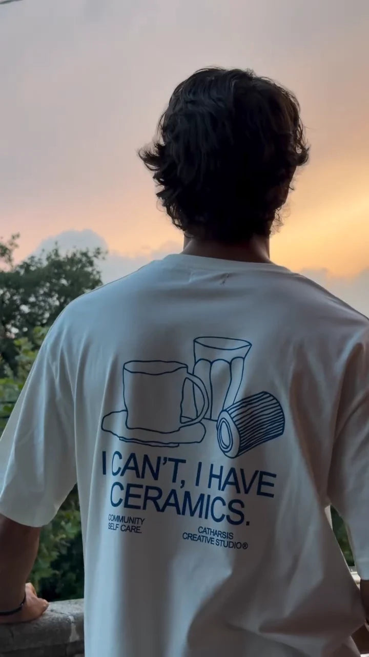 The I Can’t, I Have Ceramics T-shirt seen from the front and back at sunset.