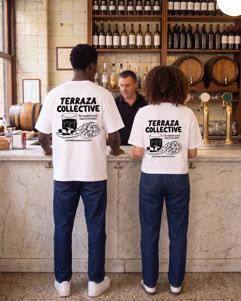 Two friends wearing the Terraza Collective relaxed and cropped T-shirts in a vermouth bar in Barcelona, back view. AI-generated image.