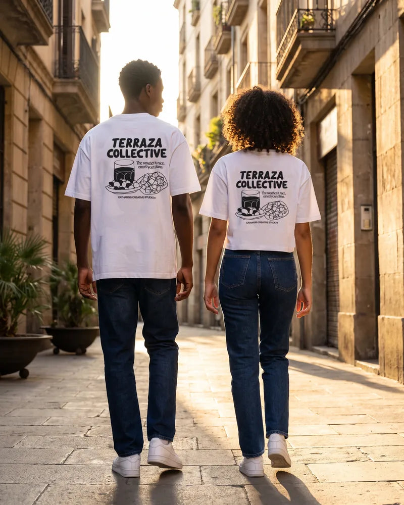 Two friends wearing the Terraza Collective relaxed and cropped T-shirts on a street in El Born at golden hour, back view. AI-generated image.