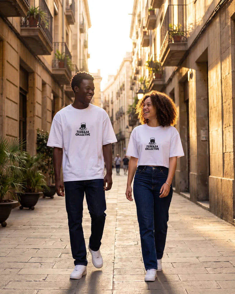 Two friends wearing the Terraza Collective relaxed and cropped T-shirts on a street in El Born at golden hour, front view. AI-generated image.