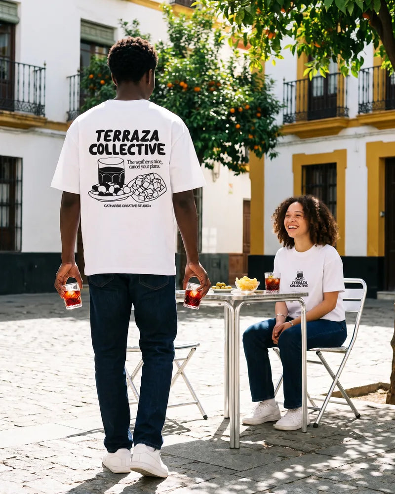 Two friends wearing the Terraza Collective relaxed and cropped T-shirts at a terrace in Seville, back view. AI-generated image.