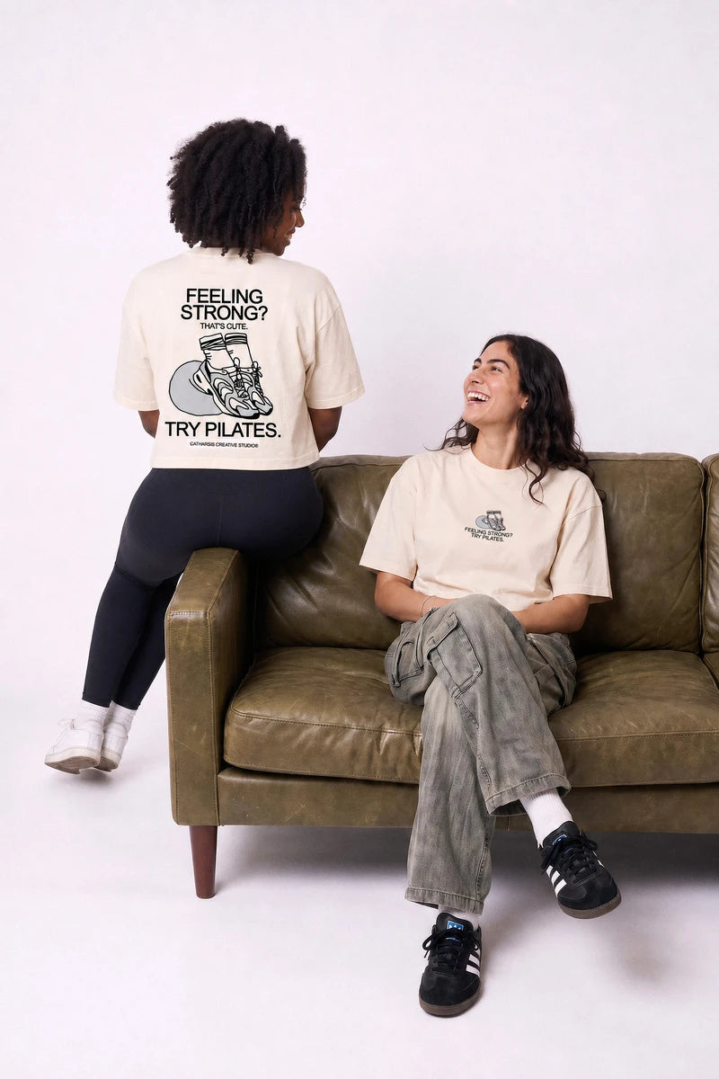 Try Pilates digital campaign: cropped T-shirt, back view, in the sofa scene. Image created or edited with AI.