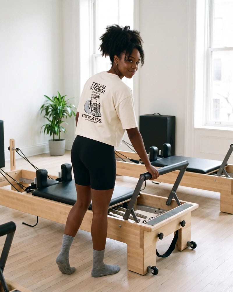 Try Pilates digital campaign: cropped T-shirt, back view, in the studio scene. Image created or edited with AI.